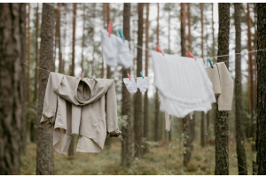 natural coloured clothing hanging on a washing line in the woods 