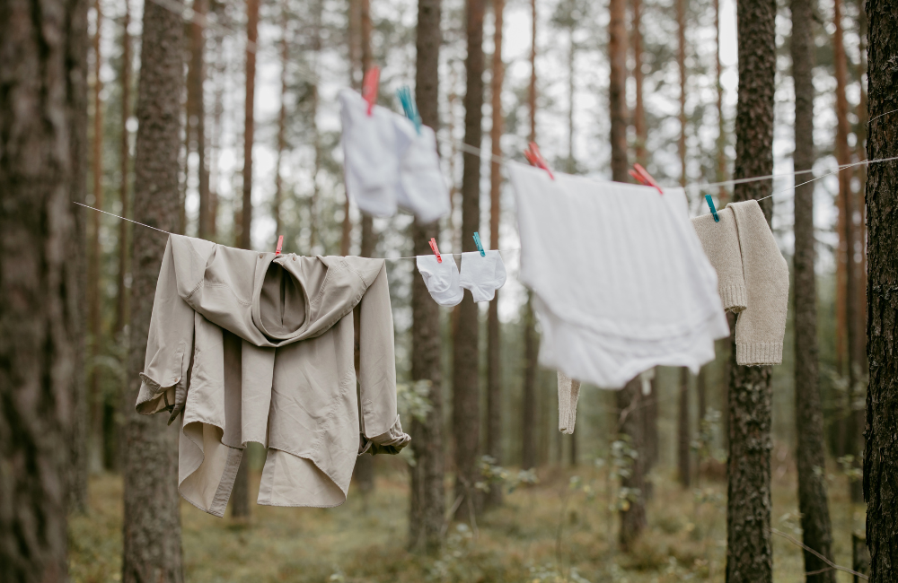 natural coloured clothing hanging on a washing line in the woods 