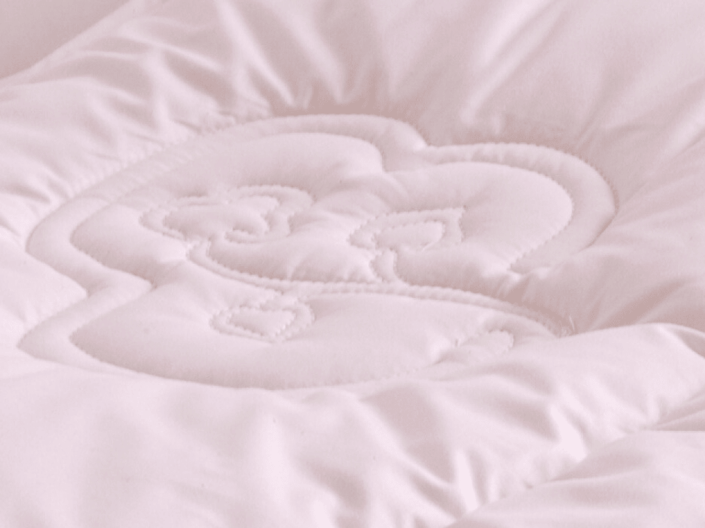 The Greenfibres bud logo embroidered into our organic duvets